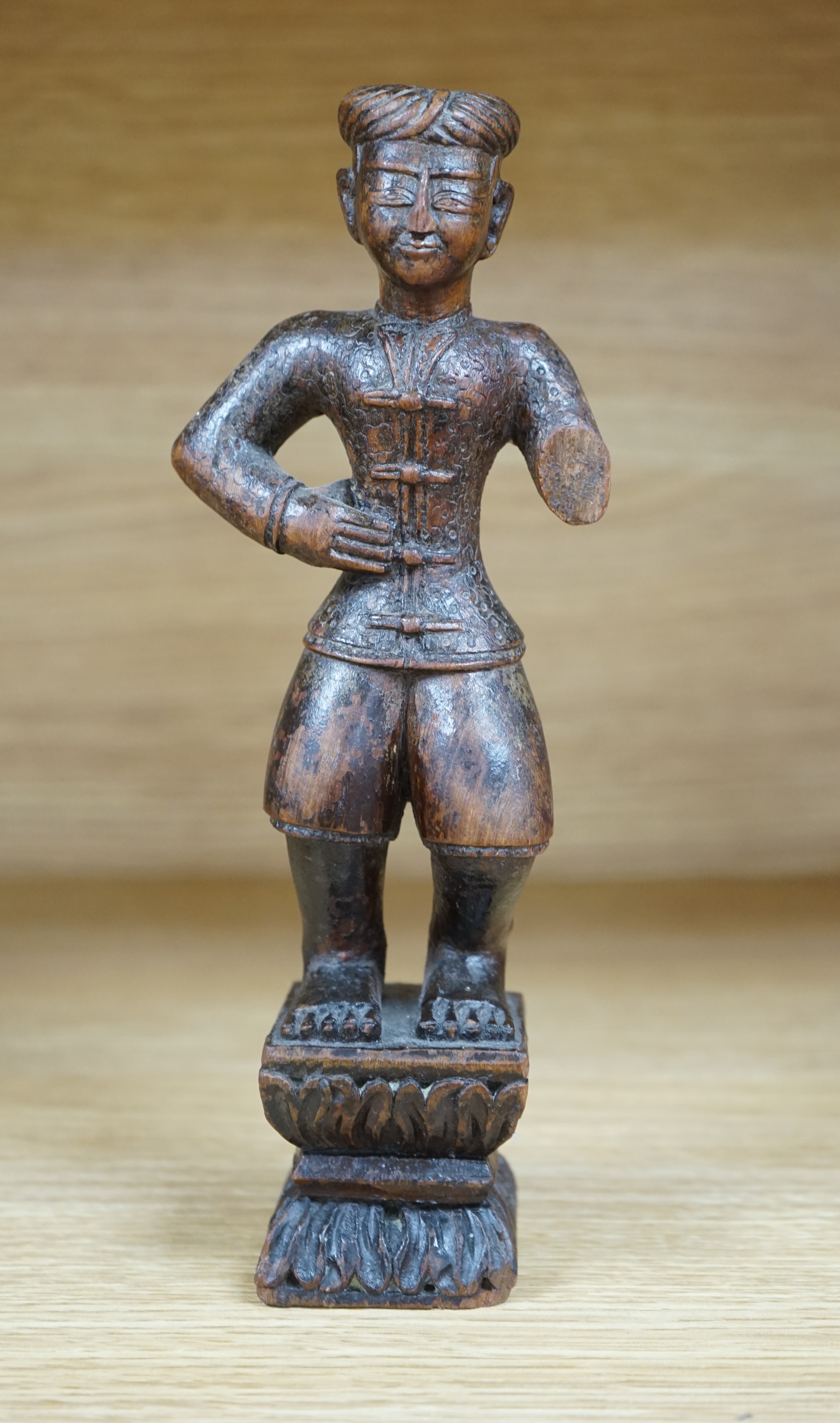 A 19th century Indian carved wood figure of a man, 23cm high. Condition - poor to fair, one arm missing